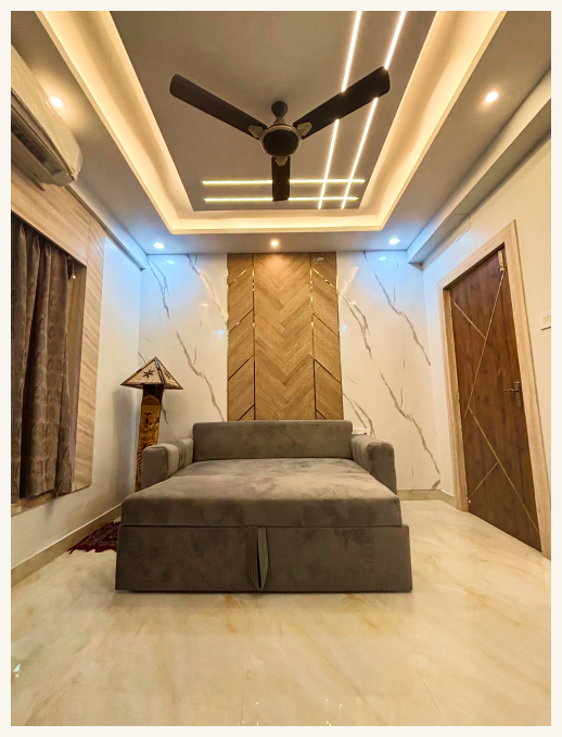Bedroom with grey sofa bed and ceiling lights